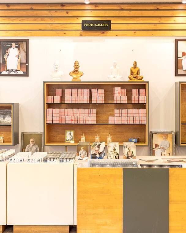 Inside the Inner Peace Museum: shelved displays, framed pictures and cabinets under warm timber.
